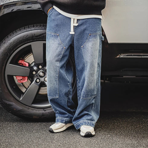 Vintage double-knee lumberjack jeans for men with distressed wide-leg design.